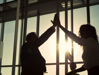 office coworkers high-fiving, energetic partnership and teamwork, striking silhouette with blurred background, generative AI
