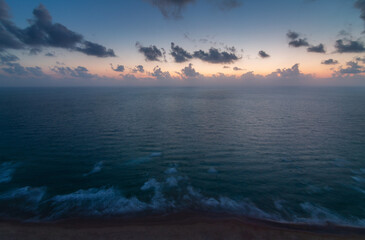 Sea coast, top evening view. Clean sea, waves and sunset