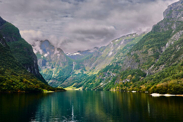 Fototapeta na wymiar mountains and clouds at the narrow fiord