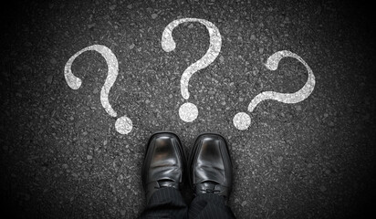 Black business shoes and three question marks - problem concept