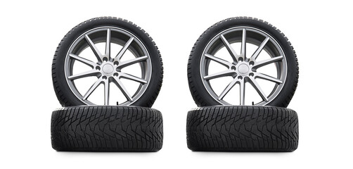 Four new good-looking snow tires isolated on white background. A set of studded winter car tires. A...