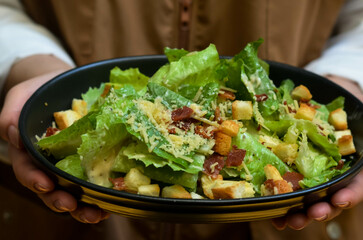Caesar salad with croutons and parmesan cheese. Fresh caesar salad on plate 