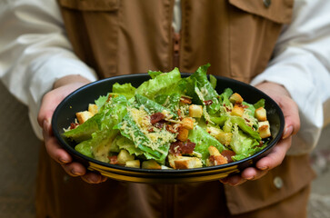 Caesar salad with croutons and parmesan cheese. Fresh caesar salad on plate 