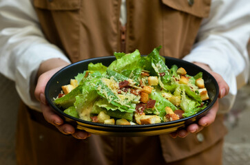 Caesar salad with croutons and parmesan cheese. Fresh caesar salad on plate 