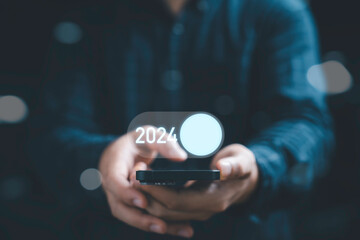 Businessman using smartphone to open toggle in 2024 , Merry Christmas and happy new year concept.