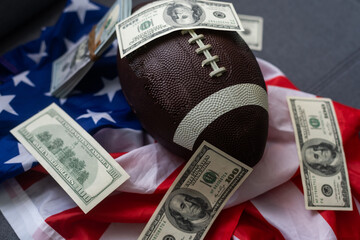 American football rugby ball and dollars on usa flag. Sports game