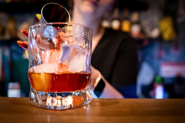 woman hand bartender making negroni cocktail