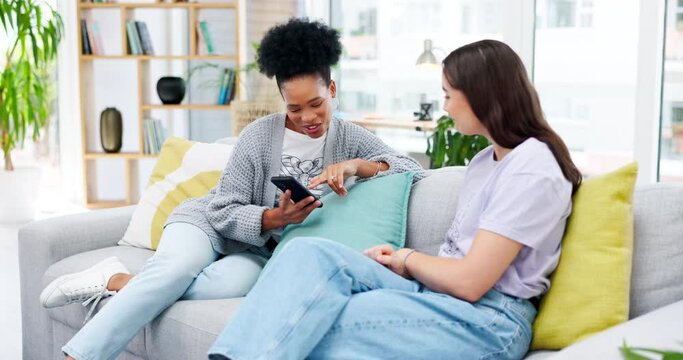 Friends, phone and women talking on sofa in living room of home, social media or internet browsing. Cellphone, girls relax or happy black woman chatting to female friend with mobile for web scrolling