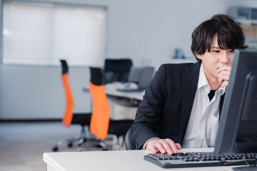 遅い時間まで一人で残業をするビジネスパーソン