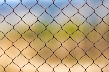 Fototapeta premium Rustic Privacy: Aged Chainlink Fence Creates the Perfect Textured Backdrop for Your Design