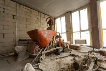 A specialized mixer for mixing dry plaster with water and automatically feeding the finished plaster.