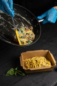 A box of spaghetti with tomato sauce 