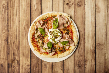 Bufalina base pizza made with a mixture of flour, salt, oil and water, seasoned with natural tomato, mozzarella fior di latte, mozzarella di bufala, cherry tomatoes and garlic