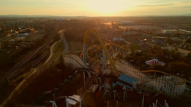 Aerial drone view of amusement park during sunset.