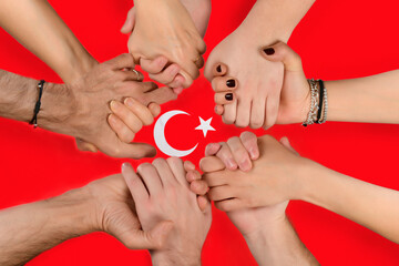 Group of people holding hands to support Turkey that suffered earthquake    