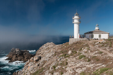 Fototapeta na wymiar lighthouse on the coast in Cabo Touriñan. Most westerly point of Peninsular Spain. A Coruña. Galicia. Camino de Santiago 