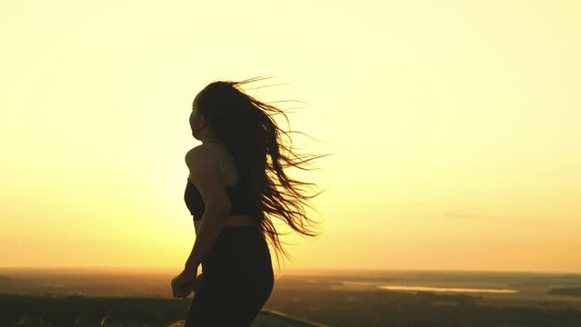young beautiful girl runs sunset. jogging sunset. athletic man sun with his hair disheveled wind. women dream beautiful body. sports running evening outdoors. relax jogging morning dawn nature.