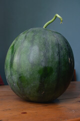 Close up of fresh and sweet watermelon on the wooden table as background