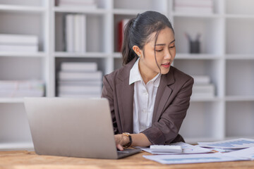 Business Asian woman working at office with documents on her desk, calculator to calculate planning analyzing the financial report, business plan investment, finance analysis concept