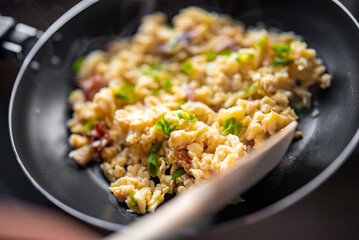 cooking tasty scrambled eggs in frying pan