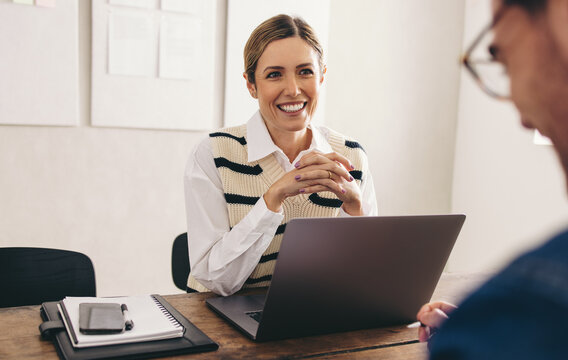Female hiring manager interviewing a job candidate in her office