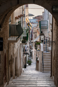 Narrow street and steep steps of Via Celestino V in early morning, Vieste, Gargano peninsula, Foggia province, Puglia