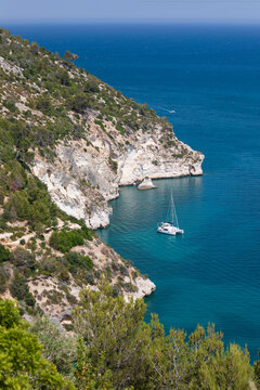 Yacht anchored off coastline near Cala del Pescecane, Gargano peninsula, Foggia Province, Puglia