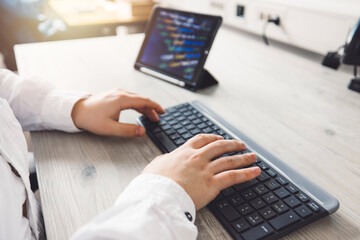 Close up unrecognizable man, programmer typing on a keyboard 