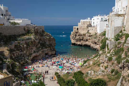 View of beach and old town on limestone cliffs seen from Ponte Borbonico su Lama Monachile bridge, Polignano a Mare, Puglia