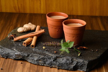 Earthen tea cup or Chai in kulhad with Ginger, Cardamom  Cinnamon tulsi