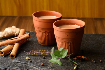 Earthen tea cup or Chai in kulhad with Ginger, Cardamom  Cinnamon tulsi