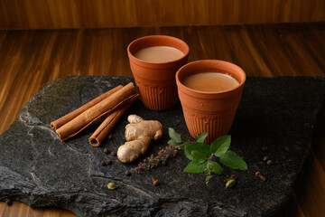 Earthen tea cup or Chai in kulhad with Ginger, Cardamom  Cinnamon tulsi