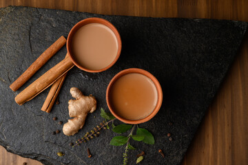 Earthen tea cup or Chai in kulhad with Ginger, Cardamom  Cinnamon tulsi