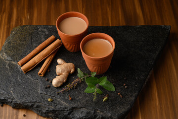 Earthen tea cup or Chai in kulhad with Ginger, Cardamom  Cinnamon tulsi