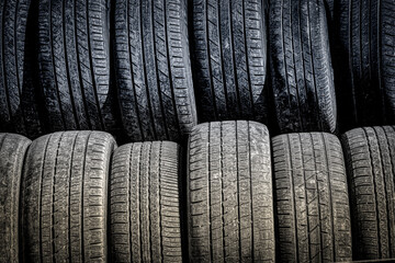 Obraz premium Two stacks of new tires outside a garage in Binghamton in Upstate NY. 