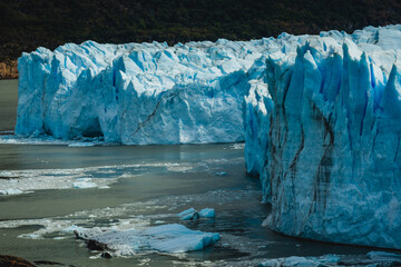  iceberg glacier under hot sun in Antarctica , glacier melting causing rising sea level global warming climate change concept