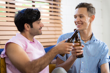 LGBTQ gay couple doing activities together at home and socializing together happily.