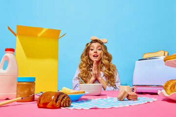 Food pop art photography. Image of excited woman putting hands together with hunger eyes on pink tablecloth over light blue background