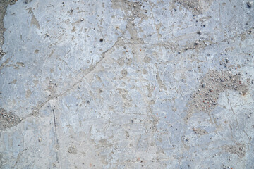 Grey concrete surface with many scratches