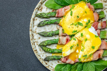 asparagus with bacon, poached egg and hollandaise sause. Food recipe background. Close up.