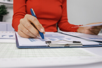 Close-up shot of busy woman paying bills online on computer to calculate household finances or taxes on the machine.