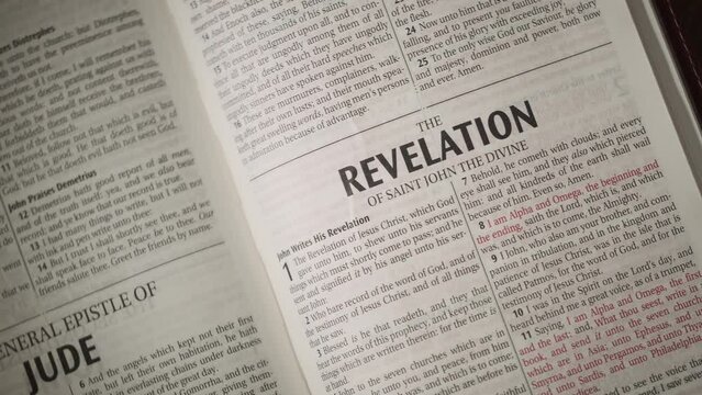 Open Bible chapter Revelation by John close up camera movement to the right  on title.