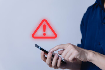 Businessman using smartphon showing warning triangle and exclamation sign icon caution of dangerous problems server error	
