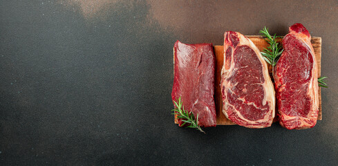 Set black angus prime beef steak variety on dark background. Steak types. Long banner format. top...