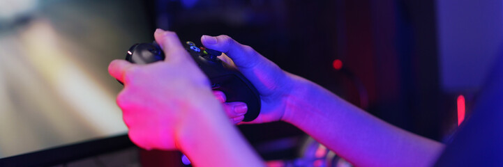 Hand of female cyber hacker gamer holding controller joystick to playing games on computer