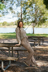 Fototapeta premium Stylish young female posing in the park during Spring