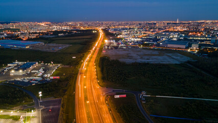 Aerial above view of the bigger highway with trafficnext to forest and the historical and at same...