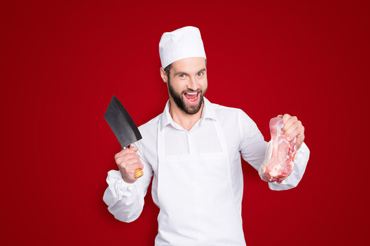 Portrait of crazy funny butcher with stubble having cleaver and fresh meat in arms, shouting, screaming with open mouth, isolated on grey background