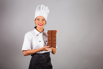 head chef, Brazilian cook, from the Northeast, holding a bar of chocolate, specialist in the...