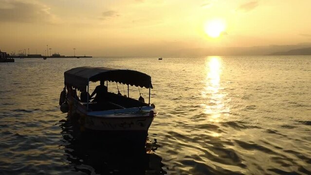 Tourist boat docked in Aqaba Jordan during sunset